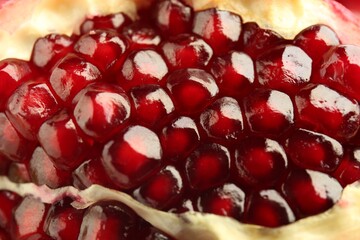 Ripe juicy pomegranate grains as background, closeup