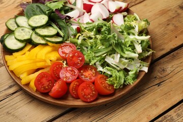 Vegetarian diet. Plate with tasty vegetables on wooden table, closeup