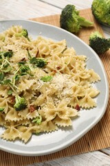 Vegetarian meal. Tasty pasta with fresh vegetables and cheese on wooden table