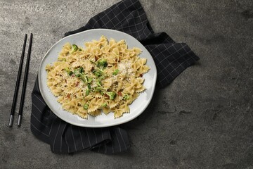 Vegetarian meal. Tasty pasta with fresh vegetables and cheese on grey table, flat lay. Space for text