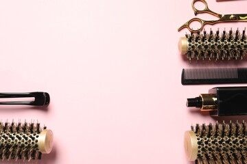 Professional hair dresser tools on pink background, flat lay. Space for text