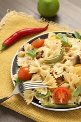 Vegetarian pasta with mushrooms, basil, string beans and tomatoes on wooden table, closeup