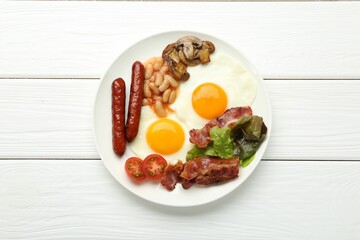 Delicious breakfast with sunny side up eggs on white wooden table, top view