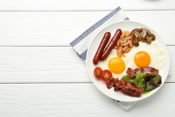 Delicious breakfast with sunny side up eggs on white wooden table, top view. Space for text