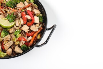 Stir-fry. Tasty noodles with meat and vegetables in wok on white background, top view. Space for text