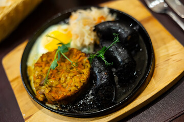 Blood sausage with barley salad and egg served on platter