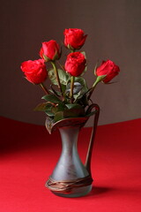 The splendor and vibrant colors of red roses; red roses in a vase
