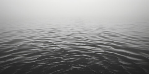 A serene black and white image of a body of water. Suitable for various design projects