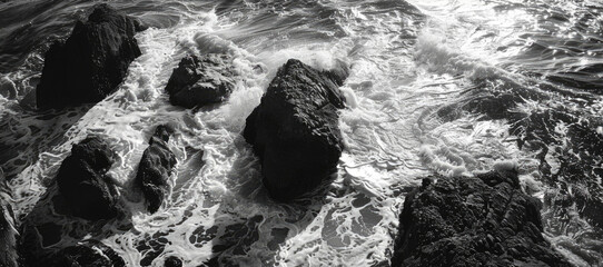A serene black and white photo of rocks in the ocean. Suitable for various design projects