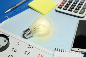 lit light bulb on desk, business concept - 758334164