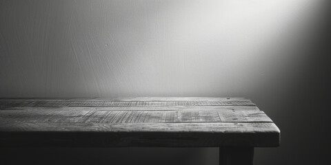 A simple black and white photo of a wooden table. Suitable for various design projects