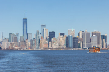 Fototapeta na wymiar Staten Island Ferry with the Lower Manhattan skyline in the distance