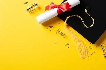 Fotobehang Flat lay composition with graduation hat, students diploma, gold tinsel on yellow background. Graduation party concept. © photoguns