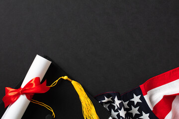 Flat lay composition with graduation cap, American flag, diploma on black background. Top view.