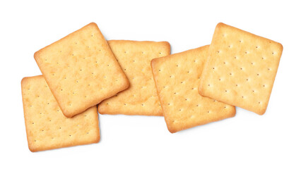 Many crispy crackers isolated on white, top view. Delicious snack