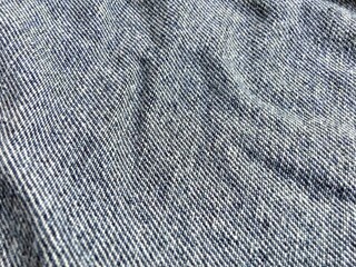 The inner surface of the jeans fabric.