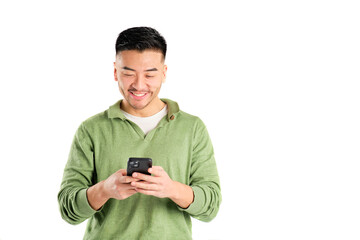 smiling asian young man in green shirt using his smart phone on white background