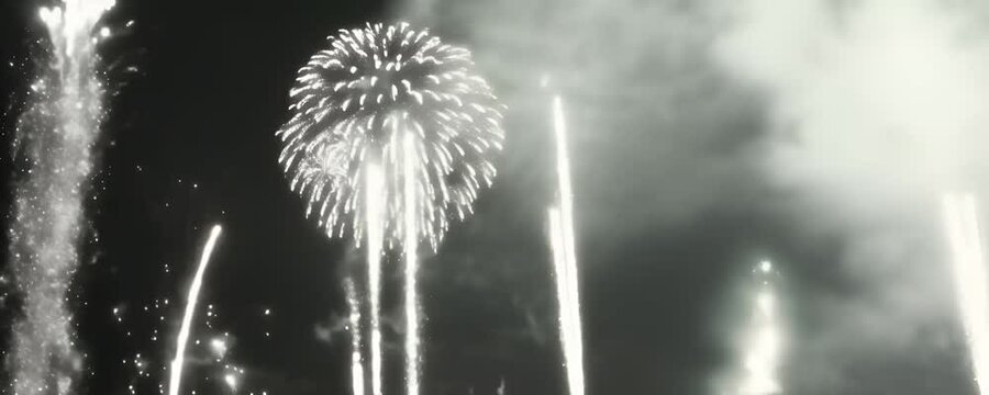 white fireworks illuminating the night sky conveying a mood of celebration and awe