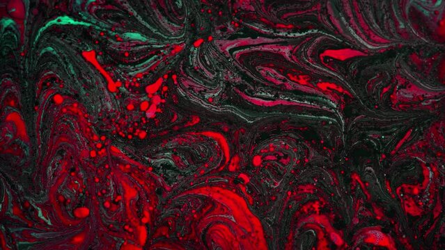 Abstract red slow of particles liquid. Floating dark moving in colorful liquid paint
