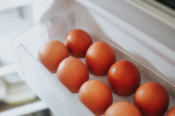 Packing eggs in a cardboard box. Eggs in the fridge