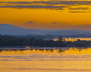 Sunrise waterscape over the bay with some light haze