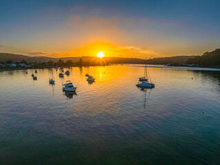 A fresh new day - sunrise waterscape with boats in the channel