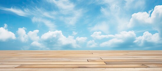 A serene wooden table set against a backdrop of a peaceful natural landscape with a clear blue sky, fluffy cumulus clouds, and a vast grassland horizon