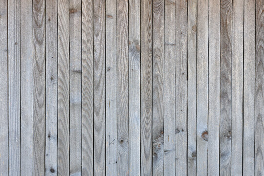The image is of a wooden wall with a grainy texture