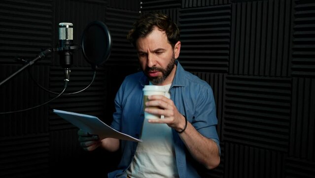 Voice actor reviewing a script and drinking some coffee before recording starts