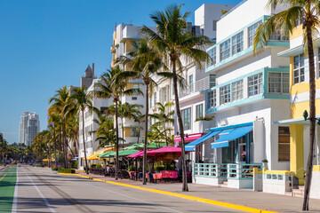 Ocean Drive in Miami Beach Florida is one of the most widely known streets in America for its historic landmark art deco buildings along the Atlantic Ocean with street closed to traffic - obrazy, fototapety, plakaty