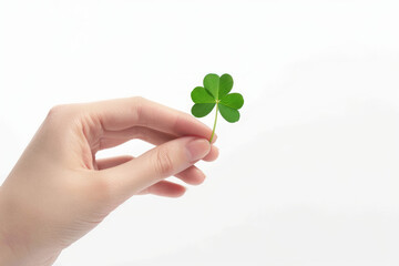 Fototapeta na wymiar A hand holding a st patricks day lucky irish four leaf clover