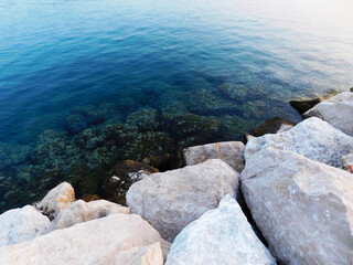 Large white stones placed to protect the coastal harbor from large waves and storms