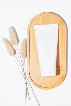 Organic cosmetic cream tube on bamboo background