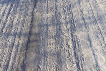 wheel tracks on an ice- and snow-covered highway