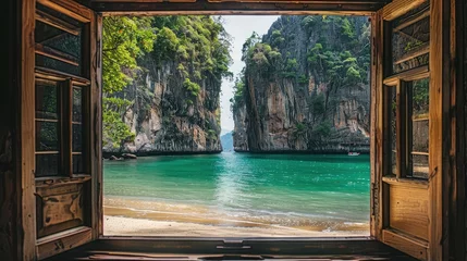Papier Peint photo autocollant Railay Beach, Krabi, Thaïlande View from the house from inside an open window to the beach with blue water, white sand beach, rocks in the background, turquoise sea water, tropical forest, sunny day. View from the window.