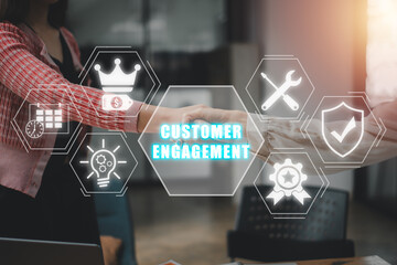 Customer engagement concept, Handshake between two businesswomen with customer engagement icon on...
