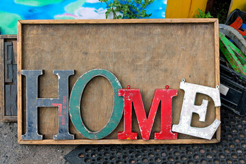 The word home spelt out in vintage metal sign letters