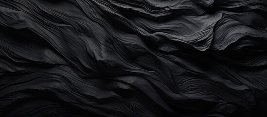 A detailed monochrome photography capturing the intricate pattern of a black marble texture, resembling the smoothness of satin and the ruggedness of rock