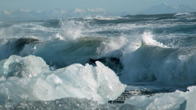 Majestic Icelandic waves on ice shore - cinematic slow motion