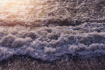 Sea waves near the coast at sunset. - 758409931