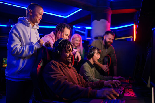 African american male gamer playing PC video game in a gameroom