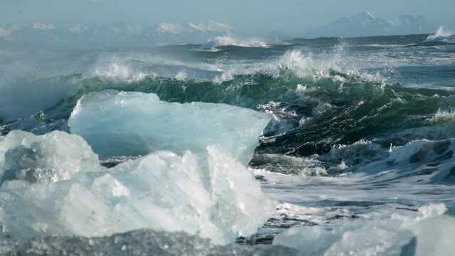 Foaming waves crashing into ice - epic slow motion