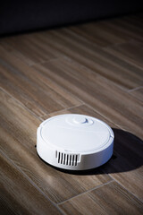 Robot vacuum cleaner in a modern living room on the floor. Smart vacuum cleaner in a smart home