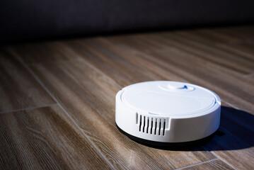 Robot vacuum cleaner in a modern living room on the floor. Smart vacuum cleaner in a smart home