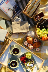 Picnic with tasty food and tea at sunset, top view