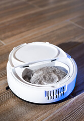 Robot vacuum cleaner in a modern living room on the floor. Smart vacuum cleaner in a smart home