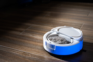 Robot vacuum cleaner in a modern living room on the floor. Smart vacuum cleaner in a smart home