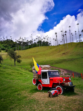 Cali, Colombia - August 13, 2018: Colombian red Jeepao with flag, coffee, in Cocora Valley.