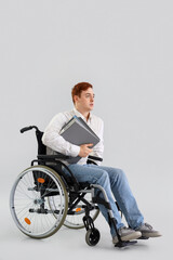 Office worker in wheelchair with folders on light background