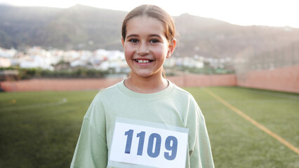 Young teenager sport woman looking at camera before running race competition